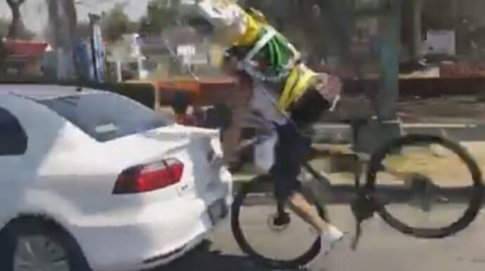 Рассеянный велосипедист разбил лицо о заднее стекло автомобиля (Видео)