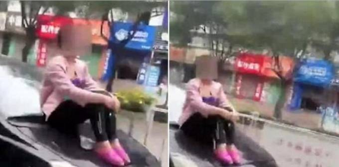 Китаянка, забравшись на капот, решила не отпускать бросившего её мужа. (Видео)