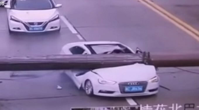 Китайский автовладелец чудом выжил, после того, как столб расплющил его автомобиль (Видео)