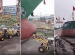 Зрелищный спуск судна на воду с использованием бульдозеров, снял рабочий в Китае