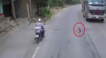 Ребёнок, выбежавший на дорогу, чудом не угодил под колёса двух фур в Китае (Видео)