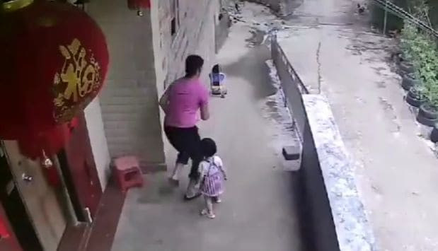 Двухлетняя девочка отправила сестру в путешествие на коляске, толкнув её со спуска в Китае (Видео)