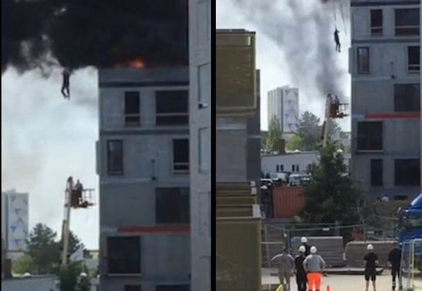 Крановщик спас строителя, спустив его на тросе с горящего здания. (Видео)